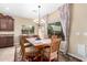 Cozy dining room featuring a classic chandelier, wooden table, and elegant window coverings at 2878 E Tonto Dr, Gilbert, AZ 85298