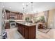Bright kitchen with stainless steel appliances, granite countertops, and an open layout to dining area at 2878 E Tonto Dr, Gilbert, AZ 85298