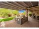 Outdoor kitchen with built-in grill, covered patio, and a landscaped backyard perfect for outdoor entertaining at 2878 E Tonto Dr, Gilbert, AZ 85298