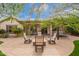 Paver patio with outdoor seating, fire pit, and access to the backyard, creating a relaxing outdoor space at 2878 E Tonto Dr, Gilbert, AZ 85298