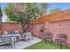 Private outdoor patio with a vibrant orange tree and comfortable seating area at 3002 N 32Nd St # 13, Phoenix, AZ 85018