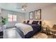 Bedroom featuring exposed brick and a modern ceiling fan at 3002 N 32Nd St # 13, Phoenix, AZ 85018