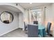 Well-lit dining room featuring grey laminate flooring, light brick accent wall, and modern decor at 3002 N 32Nd St # 13, Phoenix, AZ 85018