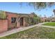 Charming brick home with lush greenery, well-kept lawn, and inviting walkway at 3002 N 32Nd St # 13, Phoenix, AZ 85018