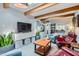 Inviting living room with wood beam ceilings, a skylight, and modern decor at 3002 N 32Nd St # 13, Phoenix, AZ 85018