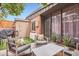 Inviting patio area with modern outdoor furniture, an orange tree, and mature landscaping at 3002 N 32Nd St # 13, Phoenix, AZ 85018