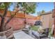 Cozy patio featuring comfortable seating, a vibrant orange tree, and a privacy fence at 3002 N 32Nd St # 13, Phoenix, AZ 85018