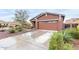 View of the home showing a spacious driveway and lovely landscaping around the property at 31062 N 136Th Ln, Peoria, AZ 85383