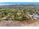 Panoramic aerial view capturing community homes, lush desert landscapes, and a picturesque mountain backdrop at 3264 E Vineyard Rd, Phoenix, AZ 85042