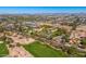 Breathtaking aerial view of a golf course community nestled amidst desert landscapes, with mountains in the distance at 3264 E Vineyard Rd, Phoenix, AZ 85042