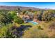 Breathtaking aerial view of home with pool and stunning desert landscape, with serene mountains in the distance at 3264 E Vineyard Rd, Phoenix, AZ 85042