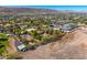 Expansive aerial view showcasing community homes, desert surroundings, and the distant mountain vista at 3264 E Vineyard Rd, Phoenix, AZ 85042