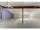 Spacious attic area with exposed beams, carpet flooring, and natural lighting at 3264 E Vineyard Rd, Phoenix, AZ 85042