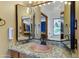 Bathroom features vanity with a granite top and copper sink, lit by decorative light fixtures at 3264 E Vineyard Rd, Phoenix, AZ 85042