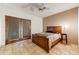 Cozy bedroom features a wooden bed frame and sliding glass doors at 3264 E Vineyard Rd, Phoenix, AZ 85042