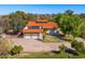 Charming single-story home featuring a terracotta roof, three-car garage, solar panels, and well-manicured lawn at 3264 E Vineyard Rd, Phoenix, AZ 85042
