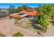 Lovely single-story home boasting a terracotta roof, three-car garage, solar panels, and desert landscaping at 3264 E Vineyard Rd, Phoenix, AZ 85042