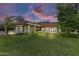 Spacious single-Gathering home boasts a large front yard, a two-car garage, and a charming tile roof at 3264 E Vineyard Rd, Phoenix, AZ 85042