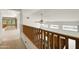 Second story hallway featuring wood railing and bright white paint at 3264 E Vineyard Rd, Phoenix, AZ 85042
