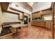 Traditional kitchen features wooden cabinets, granite counters, and a charming breakfast nook with built-in seating at 3264 E Vineyard Rd, Phoenix, AZ 85042