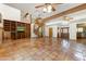 Open-concept living room with saltillo tile flooring, fireplace, and a spiral staircase to the upper level at 3264 E Vineyard Rd, Phoenix, AZ 85042