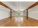 Bright, airy living room with hardwood floors and exposed wood beams at 3264 E Vineyard Rd, Phoenix, AZ 85042
