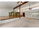 Spacious loft area with carpet flooring, exposed beams, and natural lighting at 3264 E Vineyard Rd, Phoenix, AZ 85042