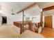 Large loft area showcasing exposed beams, wood railing, and carpet flooring at 3264 E Vineyard Rd, Phoenix, AZ 85042