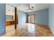 Large main bedroom features French doors, a ceiling fan, and an ensuite bathroom with vanity and lighting at 3264 E Vineyard Rd, Phoenix, AZ 85042