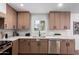 Contemporary kitchen featuring white countertops, stainless steel dishwasher, and natural wood cabinets at 3407 E Hubbell St, Phoenix, AZ 85008