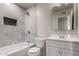 This bathroom has a tub/shower combo with tiled walls and a bright white vanity with sink at 3626 W Elm St, Phoenix, AZ 85019