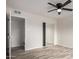 Bedroom features a ceiling fan, wood flooring, and mirrored closet doors at 3626 W Elm St, Phoenix, AZ 85019