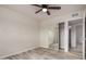 This bedroom features a ceiling fan, wood-look floors, mirrored closet and attached bathroom at 3626 W Elm St, Phoenix, AZ 85019