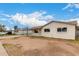 Attractive single-level home with covered parking and simplistic desert landscaping under a partly cloudy sky at 3626 W Elm St, Phoenix, AZ 85019