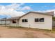 Well-kept single-story home with covered parking and simple desert landscaping under a partly cloudy sky at 3626 W Elm St, Phoenix, AZ 85019