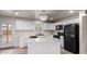 Bright kitchen boasts updated stainless steel appliances, island, and bright white cabinets at 3626 W Elm St, Phoenix, AZ 85019
