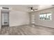 Spacious living room with attractive flooring, a modern ceiling fan, and natural light streaming in at 3626 W Elm St, Phoenix, AZ 85019