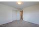 A carpeted bedroom features a double-door closet for storage at 40262 W Molly Ln # 138, Maricopa, AZ 85138