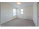 Bright, carpeted bedroom featuring natural light from two windows with blinds at 40262 W Molly Ln # 138, Maricopa, AZ 85138