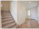 Spacious entryway showcasing a staircase and a bright front door at 40262 W Molly Ln # 138, Maricopa, AZ 85138