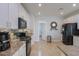 Beautiful kitchen featuring white cabinets, a black refrigerator, and an eat-in counter space for casual dining at 40262 W Molly Ln # 138, Maricopa, AZ 85138