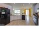 Modern kitchen with stainless steel appliances, white cabinetry, tile flooring and an open layout at 40262 W Molly Ln # 138, Maricopa, AZ 85138