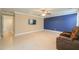 Spacious living room with tile flooring, ceiling fan, and theater-style seating at 40262 W Molly Ln # 138, Maricopa, AZ 85138