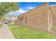 Tan home featuring a lush lawn, secure door, and shaded by a large tree at 4258 N 68Th Dr, Phoenix, AZ 85033