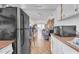 Long view of kitchen with a refrigerator, microwave, and long tile floor at 4258 N 68Th Dr, Phoenix, AZ 85033