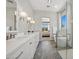 Bright bathroom featuring double sinks and a glass-enclosed shower with a separate tub, ideal for relaxation at 440 E Aurora Dr, San Tan Valley, AZ 85140