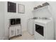 Bright laundry room with modern appliances and a convenient sorting rack for easy organization at 440 E Aurora Dr, San Tan Valley, AZ 85140