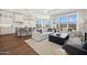 Spacious living room with hardwood floors, modern furniture, recessed lighting, and large windows at 440 E Aurora Dr, San Tan Valley, AZ 85140