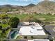 A stunning aerial view showcasing the backyard pool, lush greenery, and mountain views at 4605 E Valley View Dr, Phoenix, AZ 85044