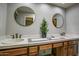 Bathroom featuring double sinks, neutral countertops, two mirrors and vanity lighting at 4605 E Valley View Dr, Phoenix, AZ 85044